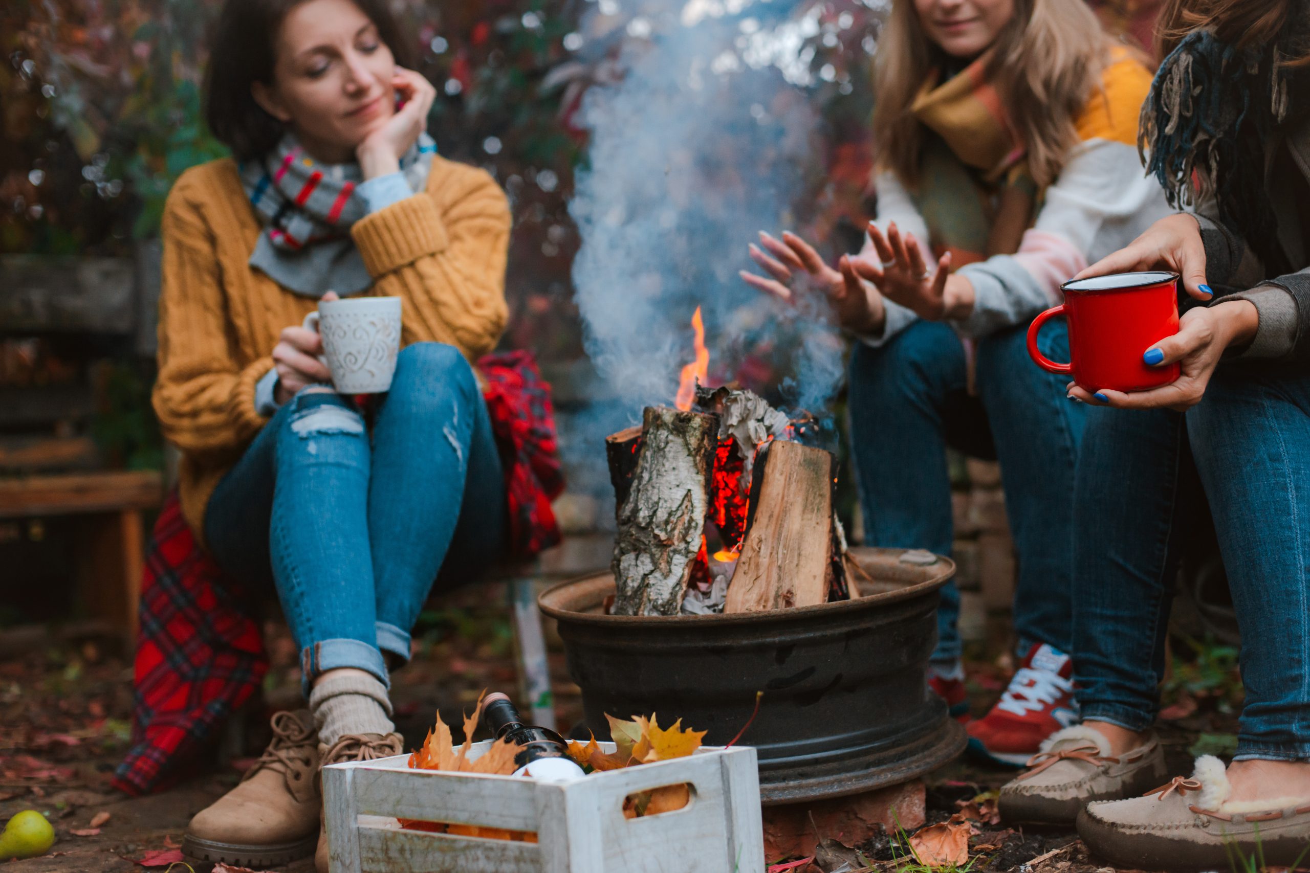 Two,Friends,Relax,Comfortably,And,Drink,Wine,On,An,Autumn